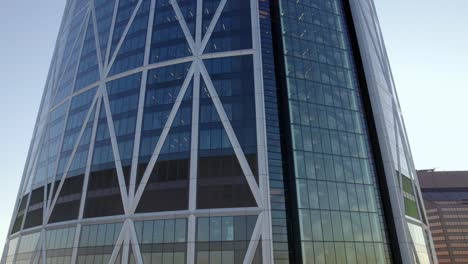 Flying-up-close-to-the-Bow-building-in-downtown-Calgary,-sunset-Canada---aerial-view