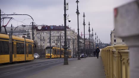 Traffic-over-Margaret-Bridge-in-Budapest,-Hungary,-driving-tram-and-cars