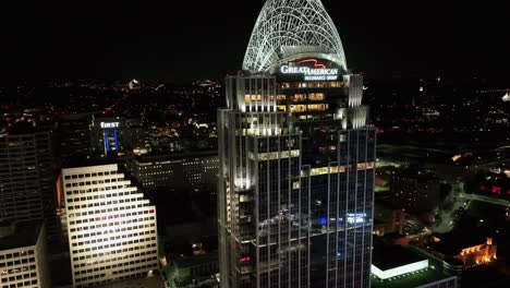 Aerial-view-around-the-Great-American-Tower-with-night-lights-in-Cincinnati,-USA