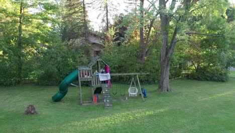 High-angle-shot-over-kids-playing-in-a-playground-in-a-park