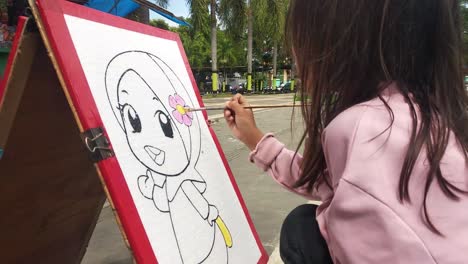 a-little-girl-coloring-pictures-on-styrofoam