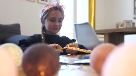 Close-up-shot-of-young-brunette-girl-make-fabric-braids-at-home