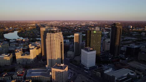 Sunlit-cityscape-of-Winnipeg,-autumn-evening-in-central-Canada---aerial-view