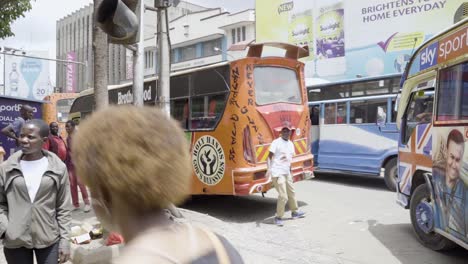 Kenya,-Nairobi-bus-stop-people-waiting-around-for-bus-to-depart