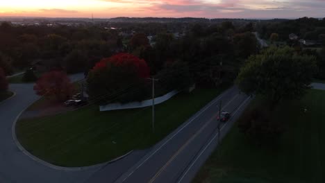 Aerial-tracking-shot-of-car-driving-on-road-at-night