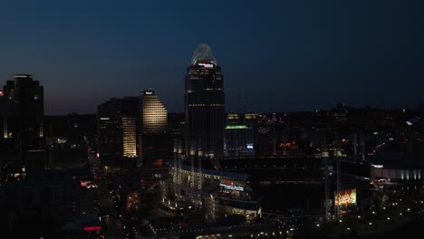 Aerial-view-over-the-Ball-Park-towards-the-Great-American-tower,-dusk-in-Cincinnati,-Ohio,-USA---approaching,-drone-shot