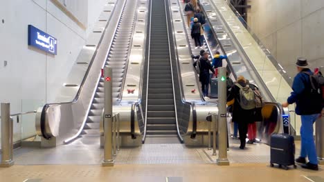 Personas-En-Escaleras-Mecánicas-En-El-Aeropuerto-De-Helsinki-vantaa,-Finlandia