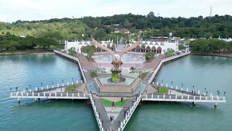 Aerial-drone-shot,-circling-the-Iconic-Dataran-Lang-Eagle-Statue-in-Langkawi