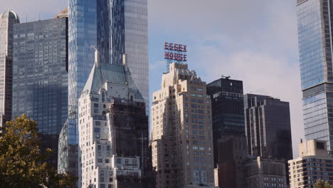 Urban-Cityscape,-Historic-and-Modern-Architecture-Towers-Buildings-in-Downtown,-New-York-City-Manhattan-Usa,-Essex-House-Hotel-Building-Surrounded-by-Glazed-Towers