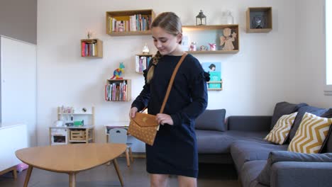 Shot-of-a-young-girl-taking-brown-handbag-from-sofa