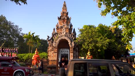 Slow-motion-street-traffic-in-front-of-ancient-Buddhist-Temple-gate