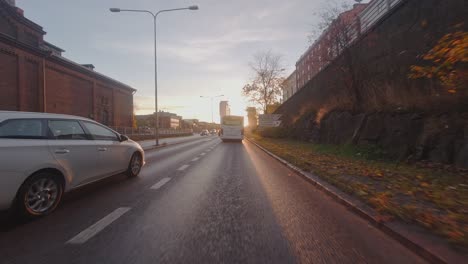 Drive-POV:-Following-transit-bus-through-underpass-into-morning-sun