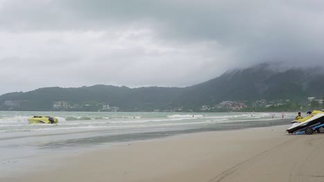 Tourist-walking-over-empty-Patong-beach-in-Phuket,-Thailand