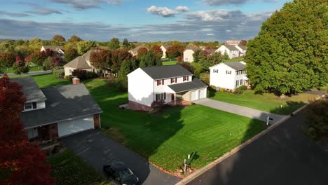 American-suburb-aerial-establishing-shot-of-autumn-red-maple-tree-in-USA