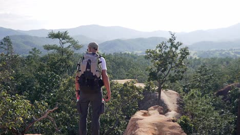 Backpacker-enjoying-the-view-on-the-top-of-a-canyon-in-Thailand