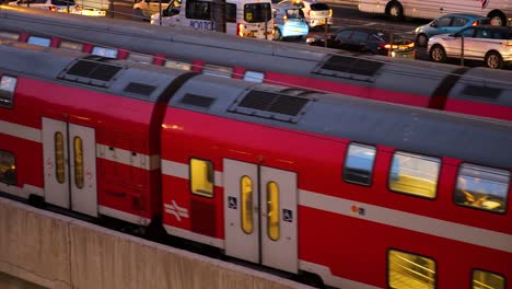 Two-trains-passing-each-other-in-opposite-direction-next-to-highway,-close-up