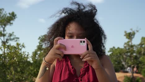 Lockige-Frau,-Die-Ein-Foto-Mit-Ihrem-Iphone-Macht