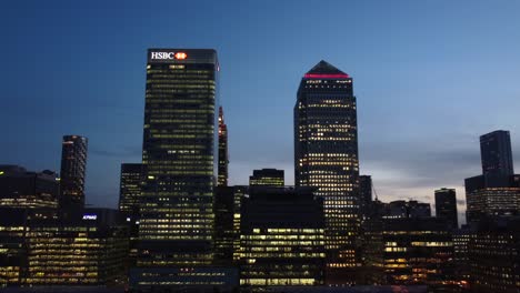 Close-up-drone-shot-skyscrapers-in-Canary-Wharf-at-night,-London