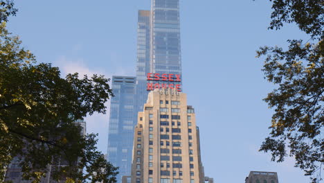 Iconic-Essex-House-Hotel-Sign-on-Top-of-Famous-Building-Overlooking-Central-Park,-New-York-City-Manhattan-Usa,-Modern-Downtown-Tower-in-Background