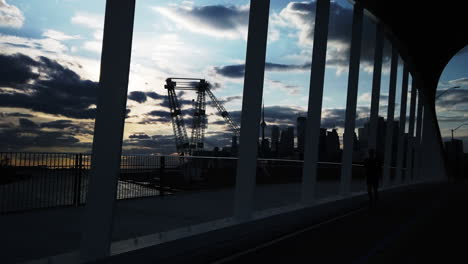 Moody-late-evening-wide-shot-of-a-jogger-and-cyclist-crossing-the-new-Cherry-Street-South-Bridge