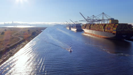 Large-cargo-ships-with-containers-parked-in-container-terminal-in-San-Francisco-Bay,-aerial-view