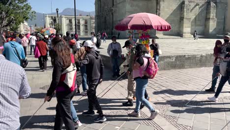 shot-of-blind-people-walking-through-the-square