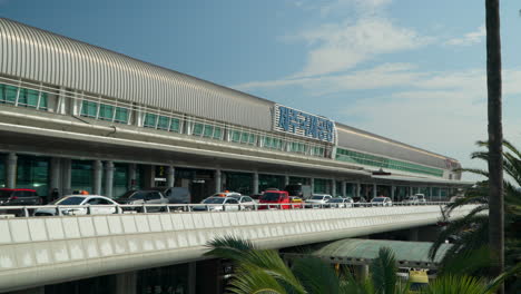 Taxis-In-Traffic-At-The-Jeju-International-And-Domestic-Airport-On-A-Sunny-Day-In-Jeju-City,-South-Korea