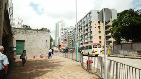 Die-Kamera-Verfolgt-Die-Geschäftigkeit-Der-Arbeiter,-Die-Auf-Der-Straße-In-Hongkong-Gehen