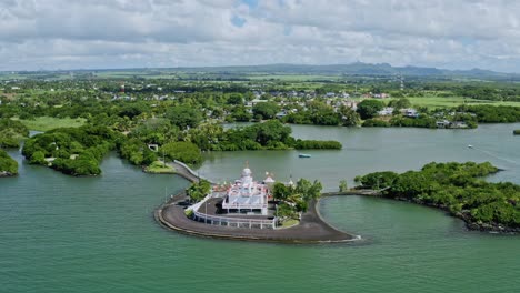 Chapel-Alone-in-Mauritius-Island,-Innovative-Architecture,-Mauritian-Aerial-Fly-Above-African-Indian-Ocean,-Mauritania,-Sea-and-Greenery-in-a-Clear-Blue-Sky