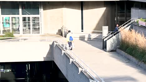 Worker-walking-over-the-National-Theatre,-London,-United-Kingdom