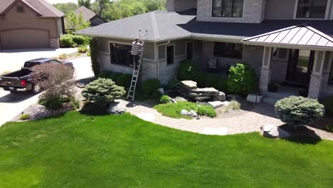 Drone-shot-of-a-Gutter-inspection-from-a-ladder-by-a-handy-man-carpenter