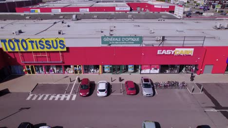 Wittenheim-Alsace-France-stores-and-suburban-landscape,-backward-aerial-overhead