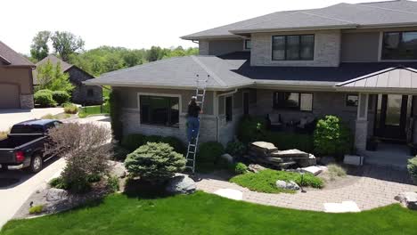 Drone-shot-of-a-Gutter-inspection-from-a-ladder-by-a-handy-man-carpenter