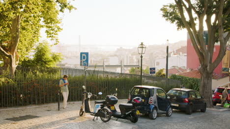 Urban-Scenery-of-Young-Guy-on-Phone-Waiting-in-Streets-of-Lisbon