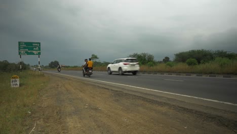 A-green-sign-board-shows-distance-of-major-cities-on-National-Highway-near-Nashik