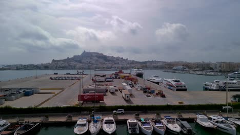 harbor-with-boats-and-luxury-yachts,-ferries-in-front-of-the-old-town-eivissa