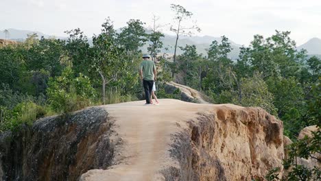 Father-and-daughter-hanging-out-in-a-nature-reserve-in-Thailand