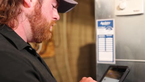 Handyman-repair-worker-examines-an-HVAC-unit-for-problems