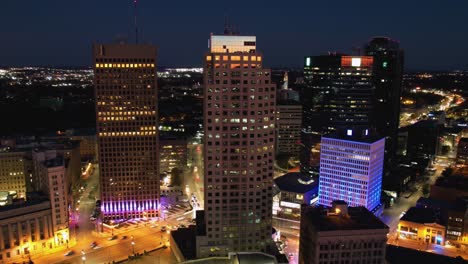 Aerial-hyperlapse-around-the-downtown-of-Winnipeg,-colorful-evening-in-Canada