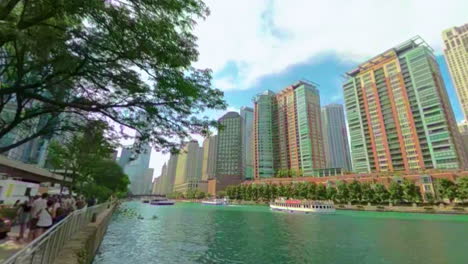 Chicago-riverwalk-wide-angle-panorama-with-busy-river-traffic-and-tall-buildings-in-background