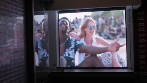 Trendy-video-advertisement-in-a-storefront-window