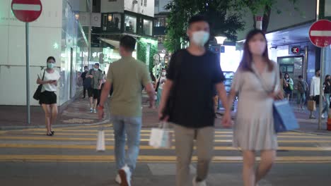 People-walking-on-the-Zebra-cross-of-night-on-one-of-the-Hongkong-streets