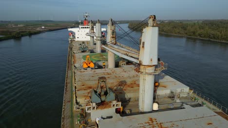 Aerial-Flying-Over-Deck-of-Sea-Prajna-Bulk-Carrier-Along-Oude-Maas-In-Puttershoek