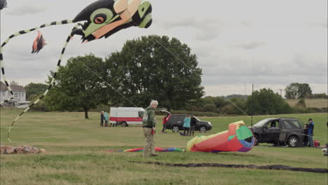 A-man-prepares-his-kites-during-a-kite-festival-on-a-dull-spring-day