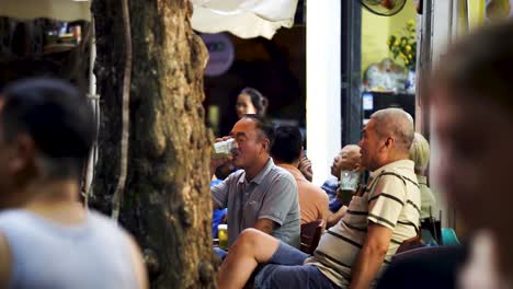 Hombre-Mayor-Bebiendo-Bai-Hoi-En-La-Calle-De-La-Cerveza-Con-Amigos-En-Hanoi-Por-La-Noche