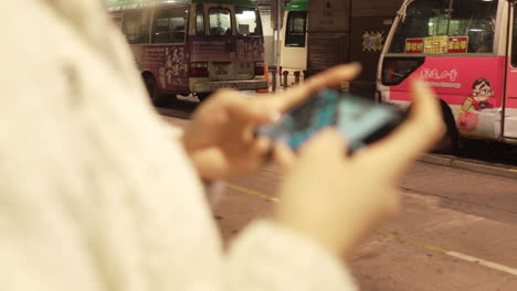 Passenger-bus-with-a-girl-in-the-foreground-playing-games-application