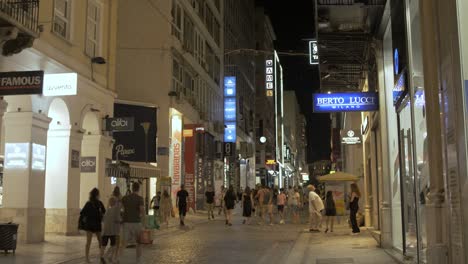 People-shopping-along-Ermou-Street-at-night-in-Athens