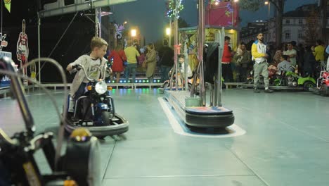 Establishing-shot,-Young-kids-ride-Bumper-cars-playground-at-San-Froilán-Festival,-Lugo