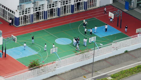 A-number-of-high-school-students-playing-basketball-on-the-court