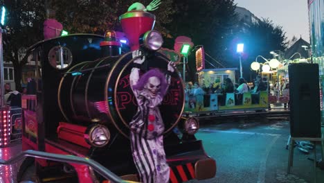 Happy-people-enjoying-Toy-train-ride-at-the-San-Froilán-Autumn-festival,-Spain